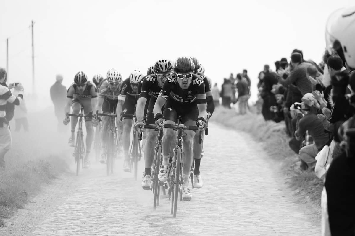 A black and white photo of a cycling race.