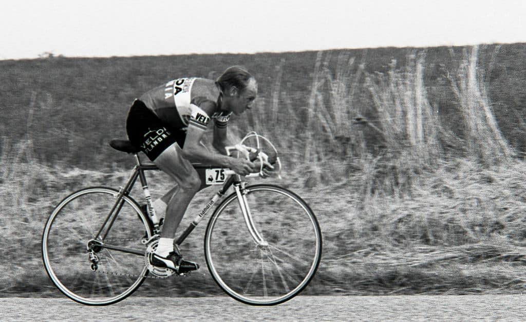 Michel Pollentier riding his bike with the number 75 tag on it.