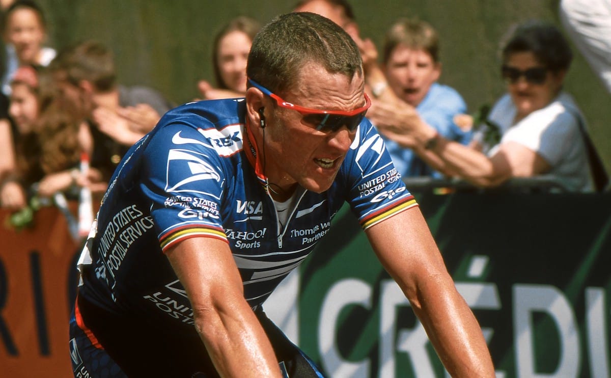 Lance Armstrong riding in a blue jersey.