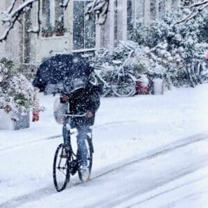 Winter Cycling with an umbrella in hand.