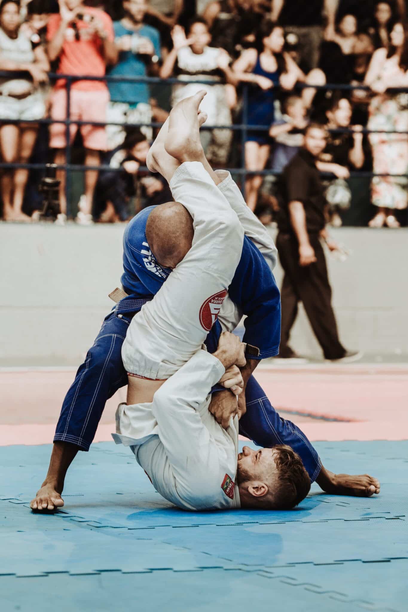 A man performs an armbar against another man.